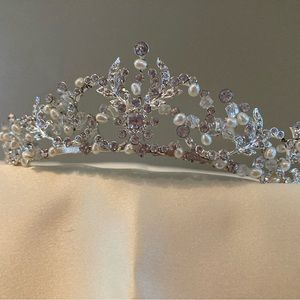 Tiara displaying Pearl and rhinestones against silver